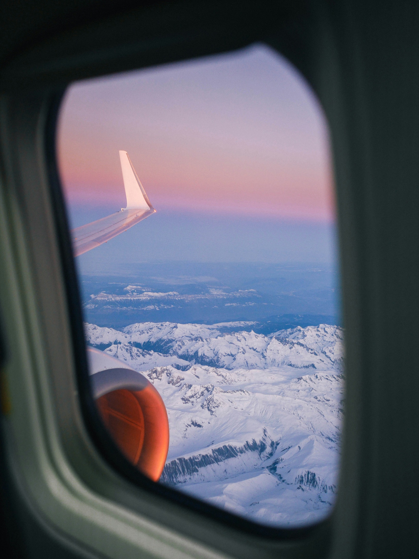A passenger view of a flight over snowy mountains