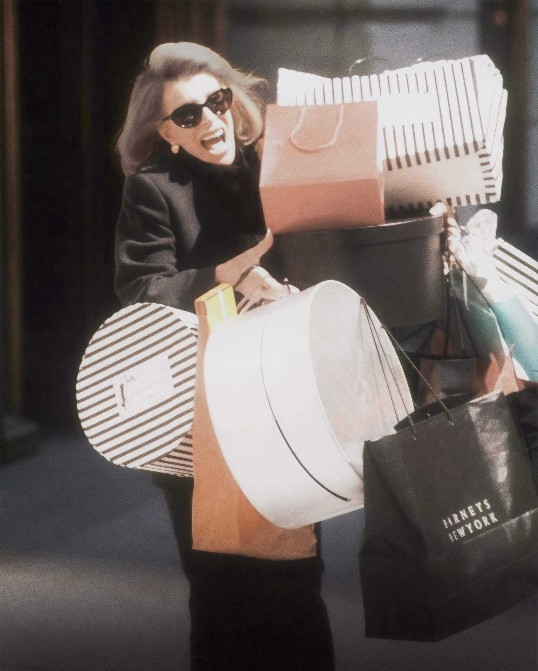 A fashion shopper carrying multiple shopping bags
